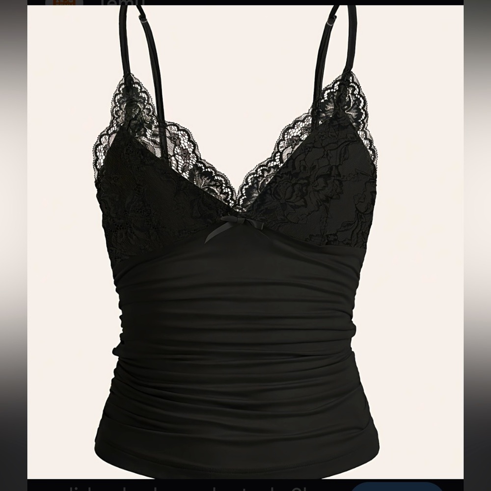 black ruched cami top features a deep V-neckline adorned with lace trim